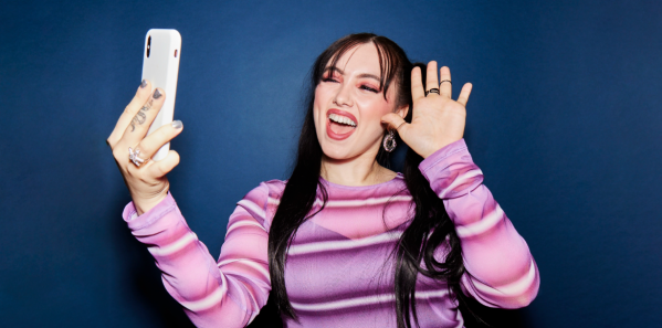 Woman smiling waving at phone